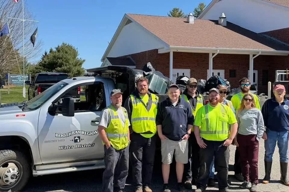 Boothbay Region Water District team volunteering for roadside trash collection: a team photo in front of BRWD's filled pickup truck